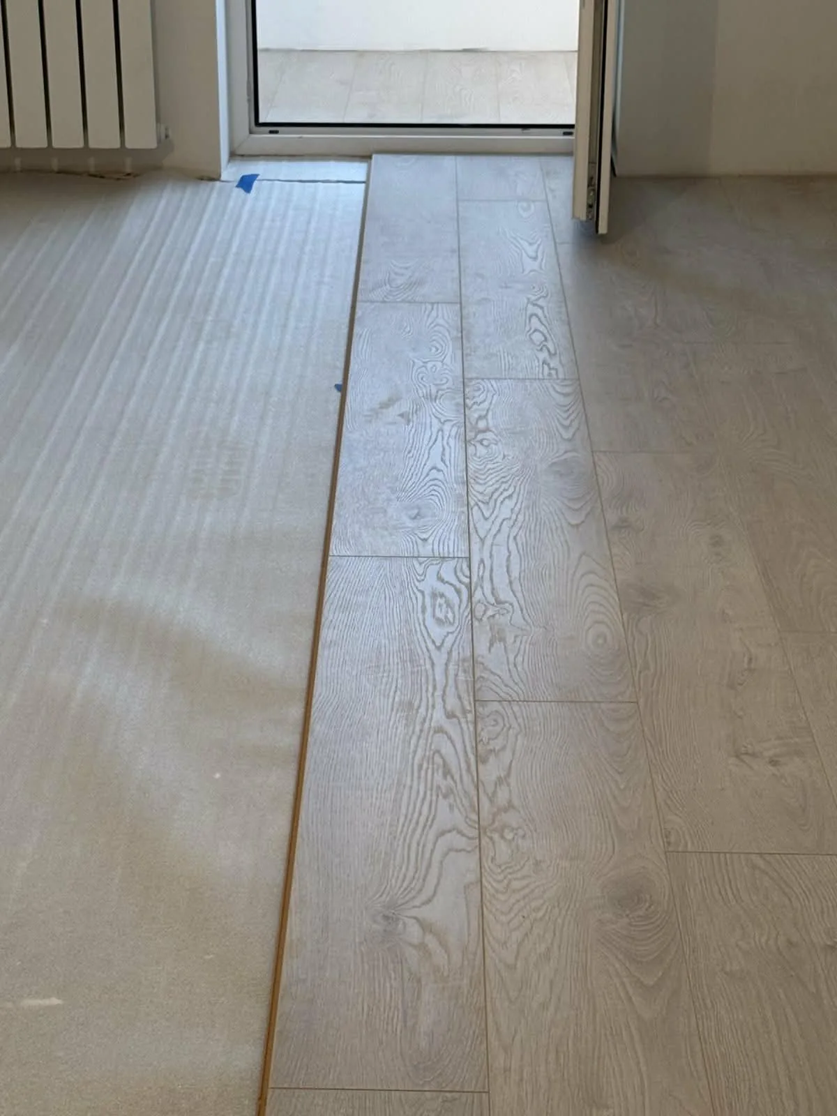 Flooring installation in progress over underlay