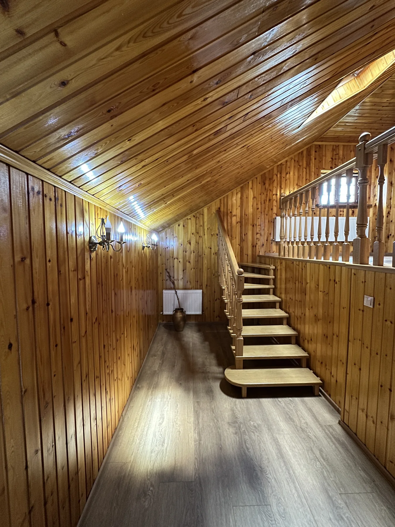 Completed flooring through a timber-lined stair hall