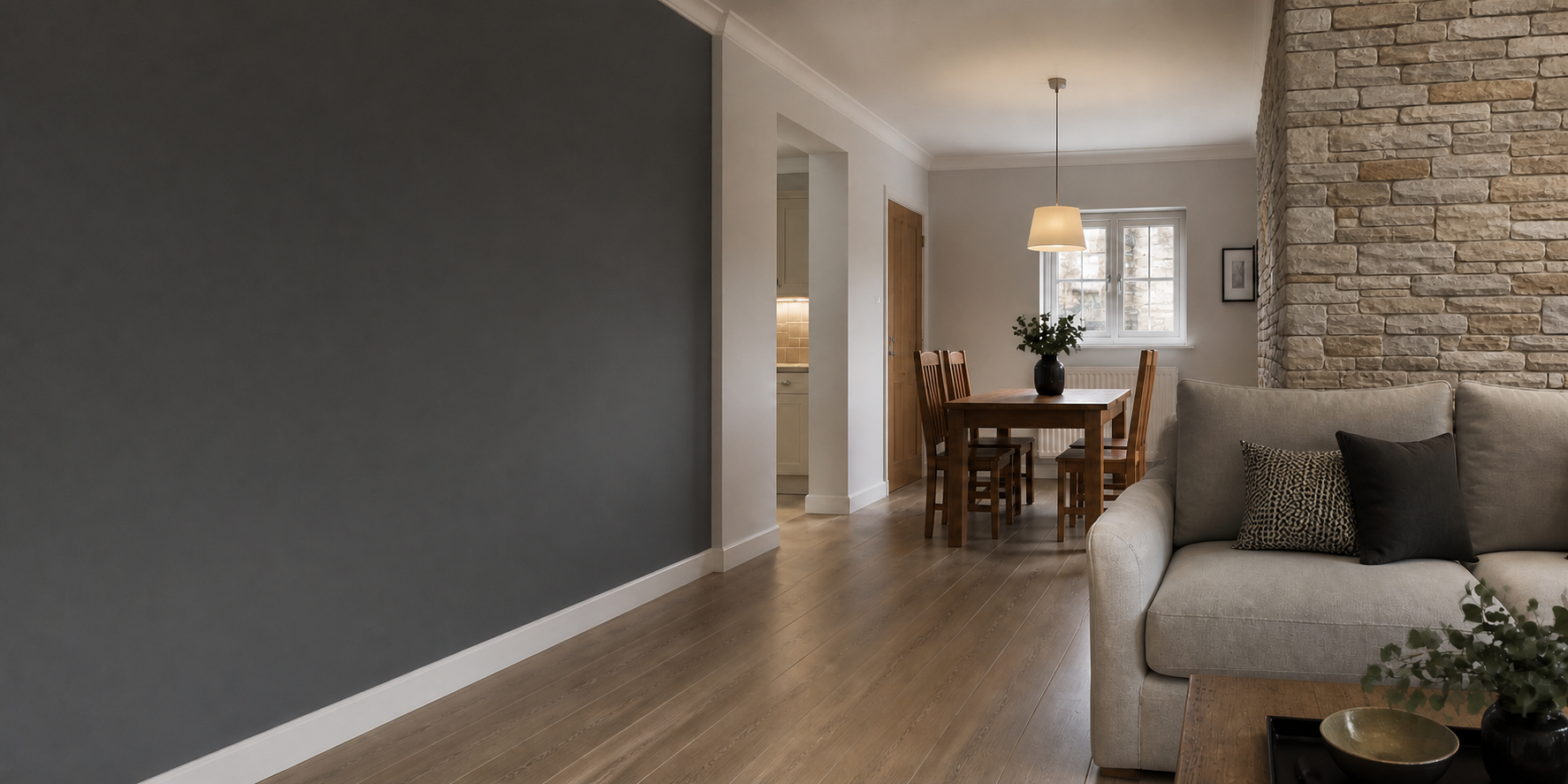 Completed living and dining interior with split-face stone feature wall