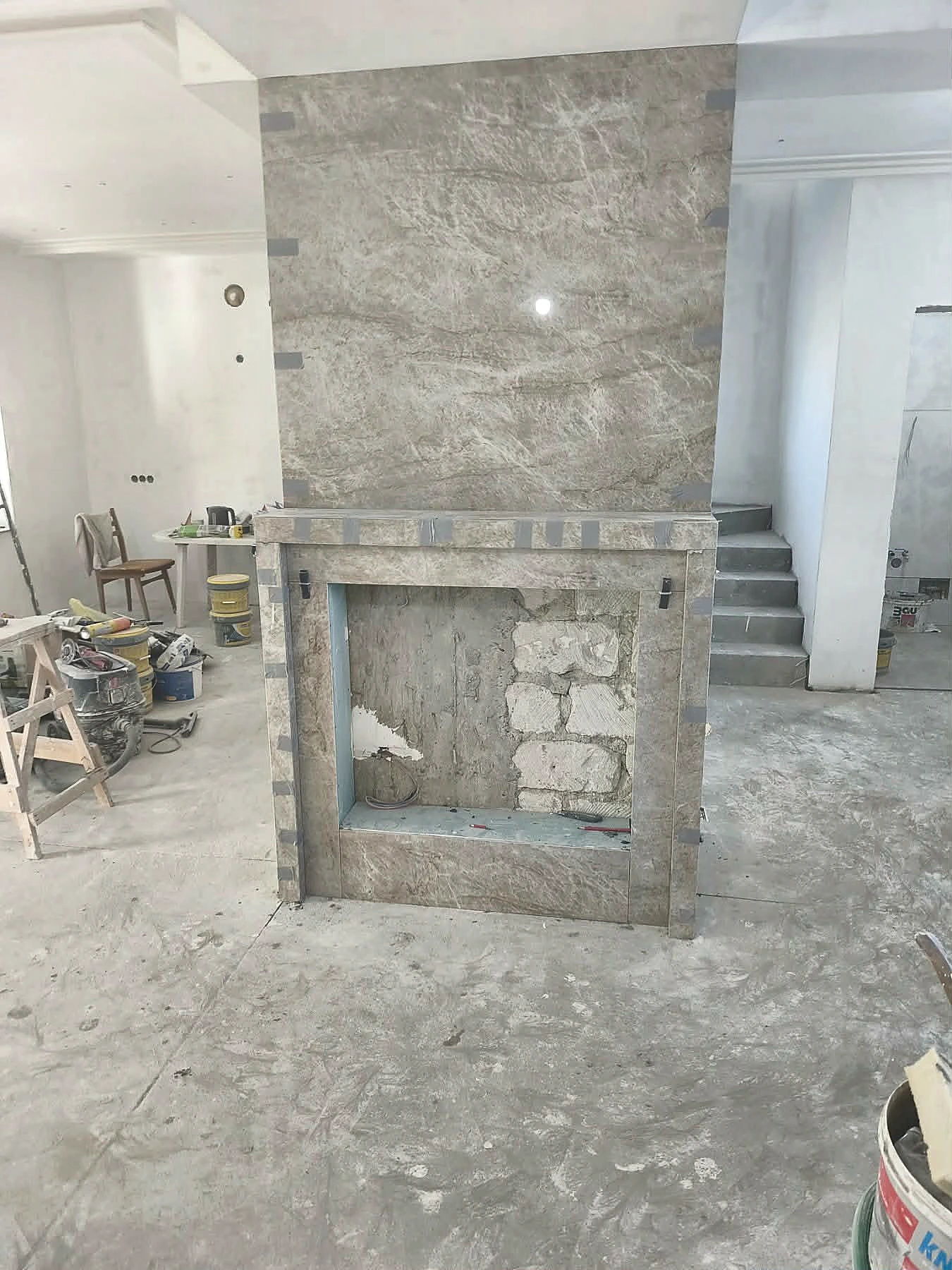 Stone fireplace surround installation in progress