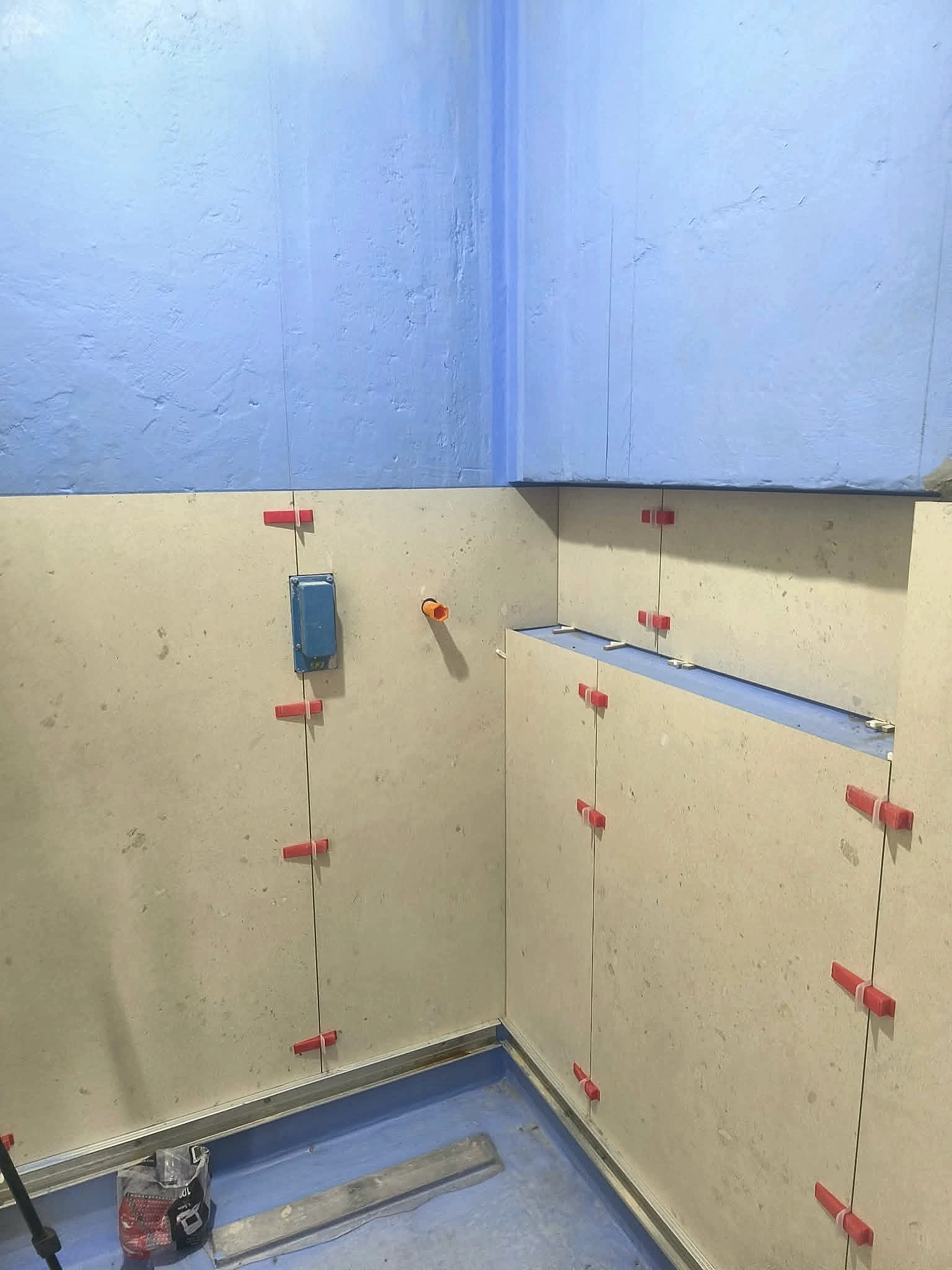 Wet-area waterproofing and wall tiling in progress