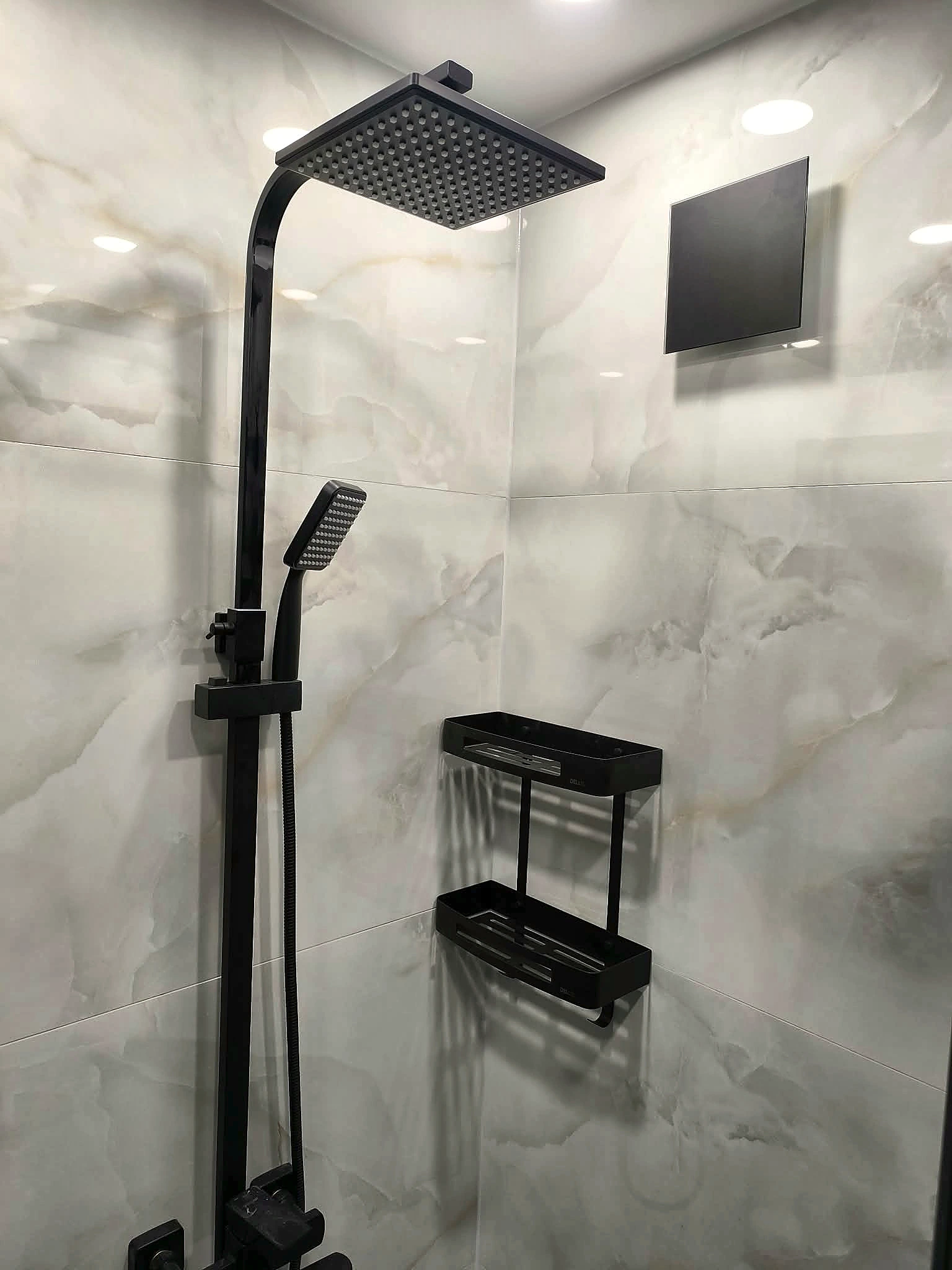 Marble-effect shower area with black fittings