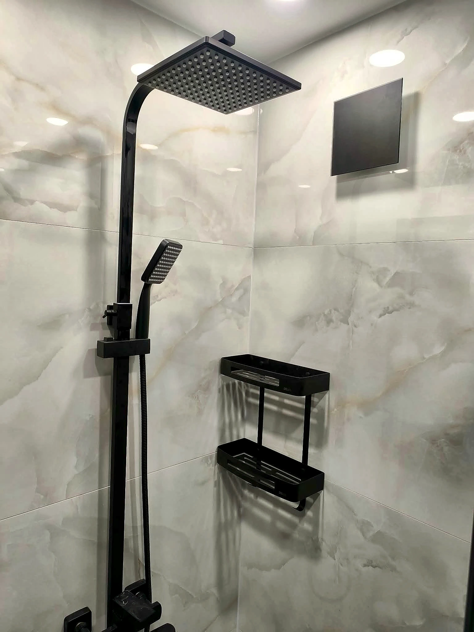 Completed shower with large-format porcelain tiles