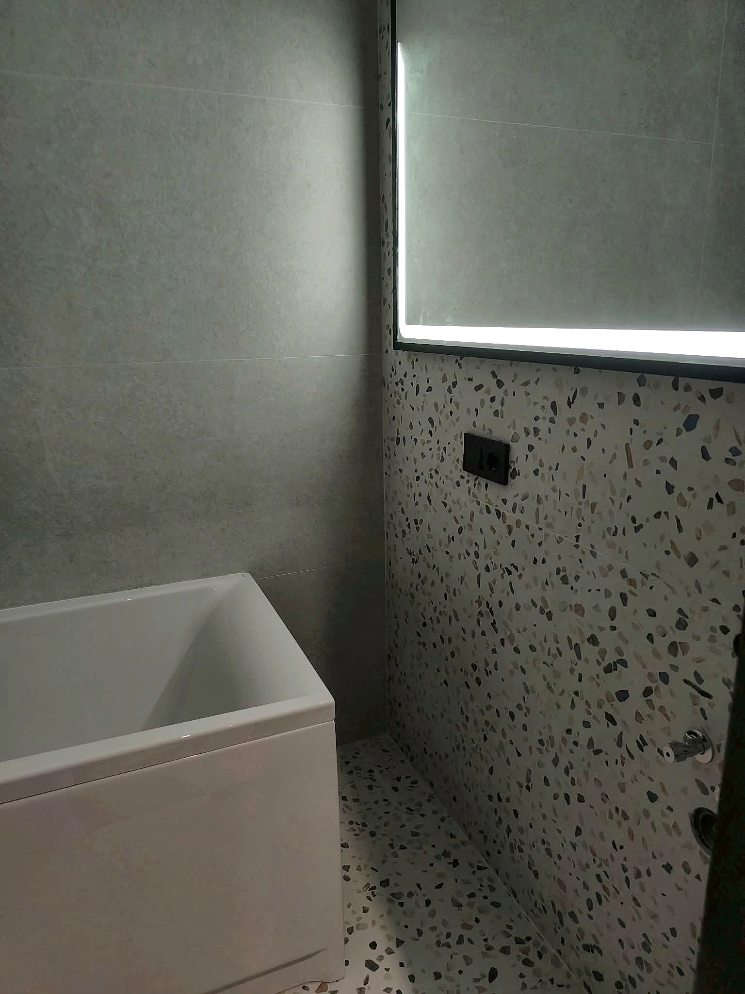 Compact bathroom with terrazzo surfaces