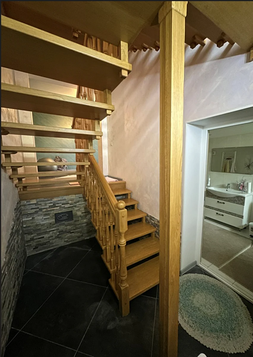 Decorative stone cladding around a timber staircase